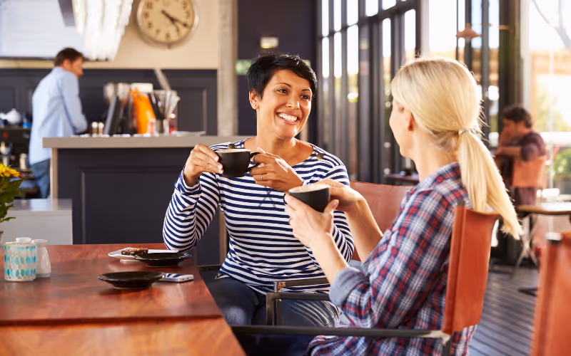 two ladies talking in a cafe